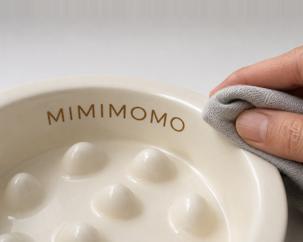 Close-up of MIMIMOMO glazed ceramic slow feeder bowl